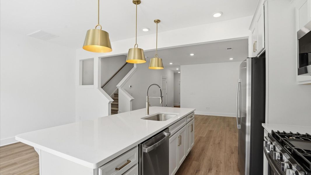 Tasteful kitchen with a streamlined island and modern finishes in a first-class DRB Homes design
