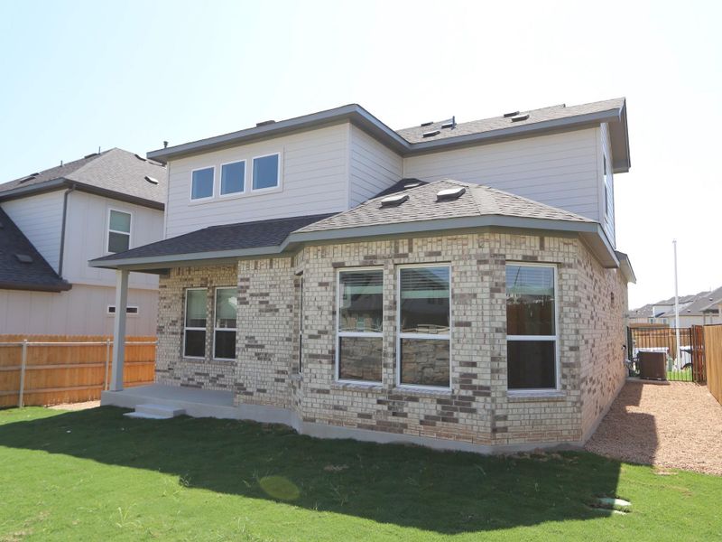 Front exterior of a new home in Cascades at Onion Creek, Austin, TX, highlighting curb appeal (Image 2).