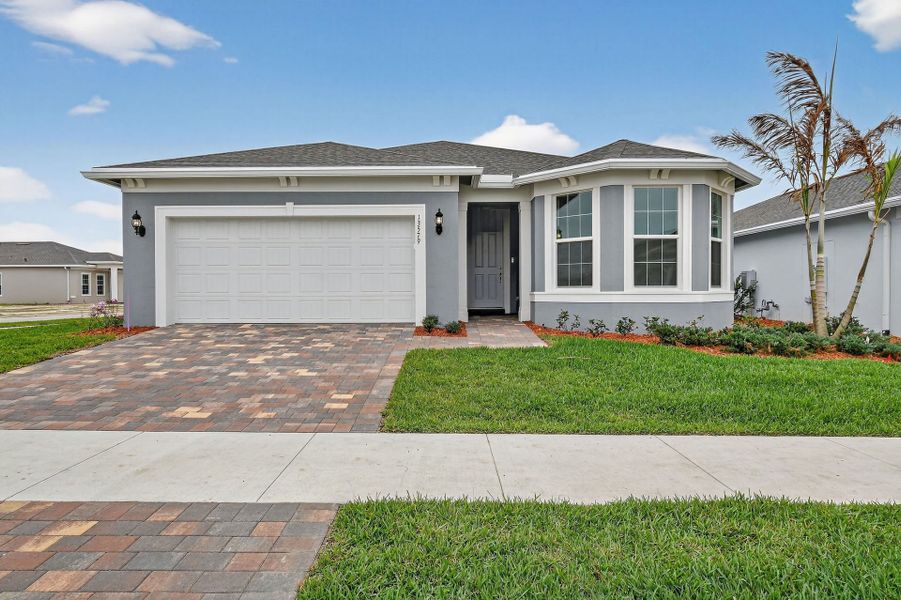 Front exterior of a new home in Del Webb Tradition, Port St. Lucie, FL, highlighting curb appeal (Image 32).