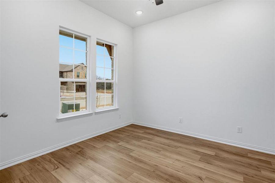Empty room featuring light wood-style floors, recessed lighting, and a ceiling fan