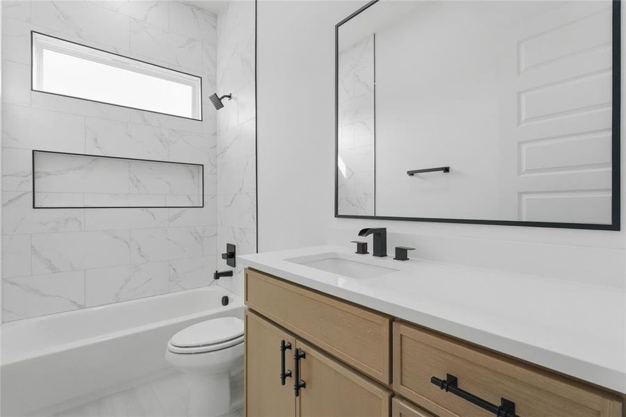 Full bath featuring vanity and shower / bath combination