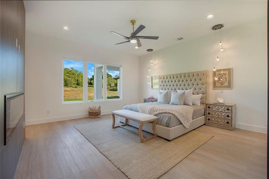 Bedroom with ceiling fan and light wood-type flooring