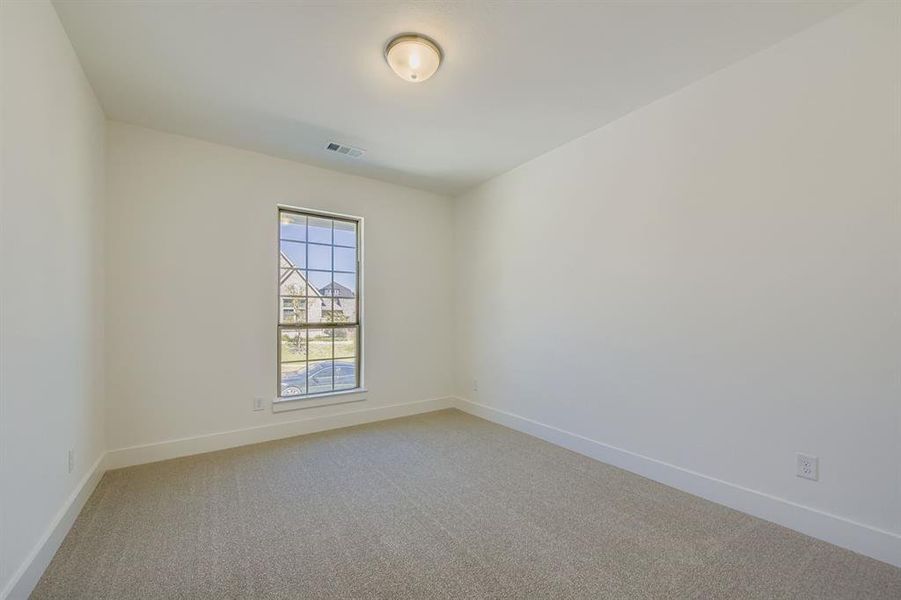 Unfurnished room featuring light carpet and baseboards Unfurnished room featuring light carpet and baseboards