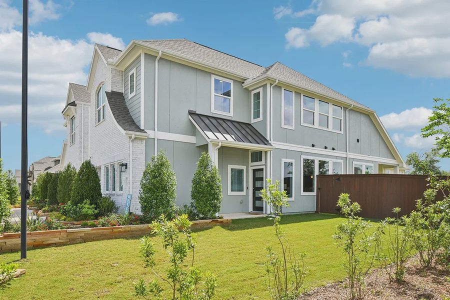 Front exterior of a new home in Meridiana Chateau, Manvel, TX, highlighting curb appeal (Image 23).