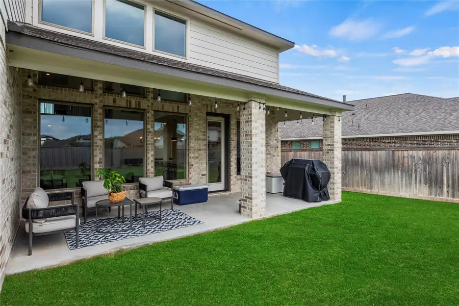 Enjoy summer BBQs and backyard birthday parties on this fabulous covered patio with room for your grill and outdoor furniture.