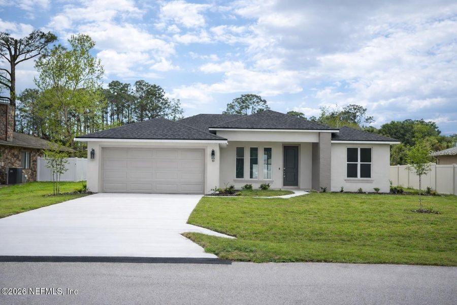 Front exterior of a new home in , Palm Coast, FL, highlighting curb appeal (Image 1). Front exterior of a new home in , Palm Coast, FL, highlighting curb appeal (Image 1).