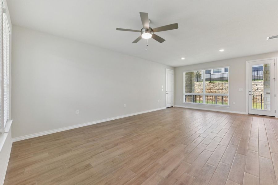 Empty room featuring light wood-style flooring, recessed lighting, and a ceiling fan Empty room featuring light wood-style flooring, recessed lighting, and a ceiling fan