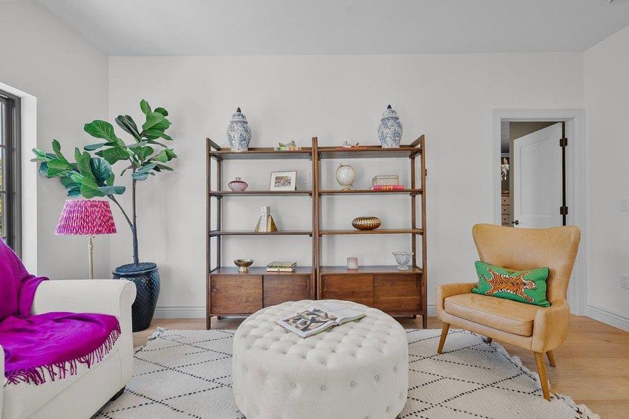 Living area featuring light wood-type flooring and baseboards