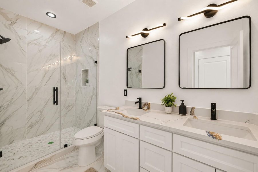 Primary bathroom with double sinks and large shower.