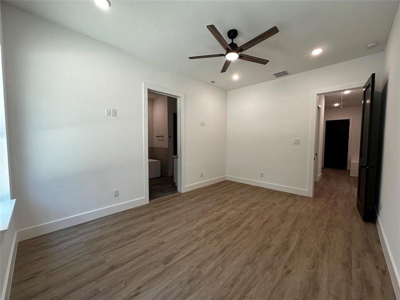 Primary Bedroom with hallway access to garage