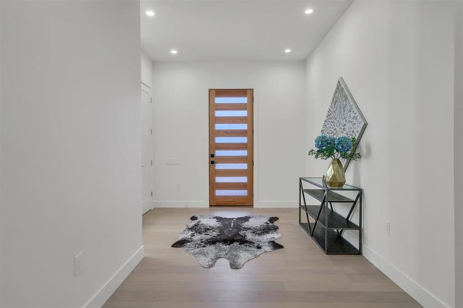 Entrance foyer with light hardwood / wood-style flooring