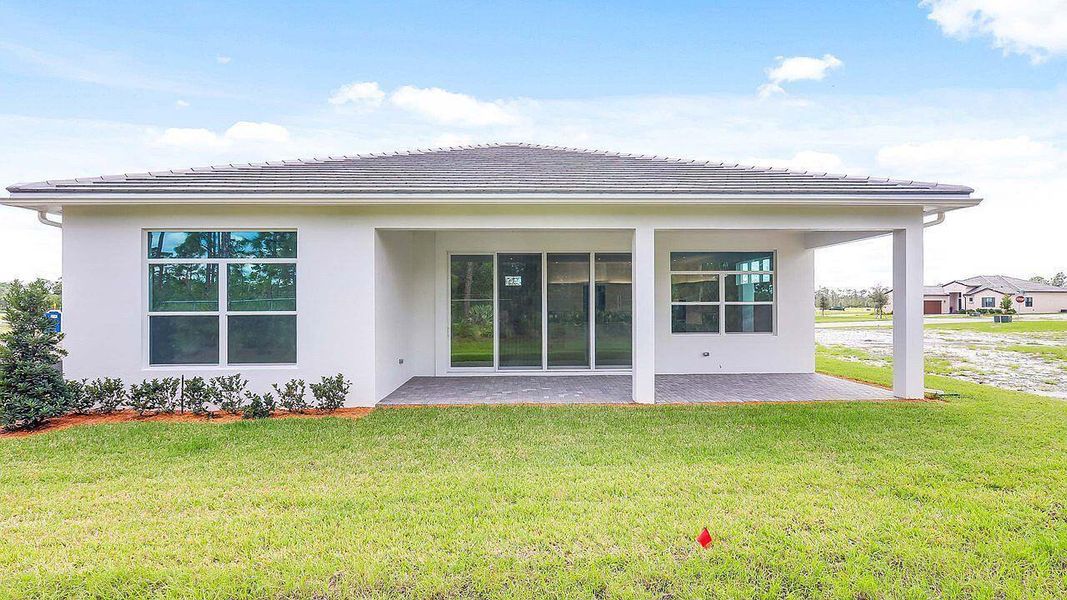Front exterior of a new home in Mosaic, Port St. Lucie, FL, highlighting curb appeal (Image 14).