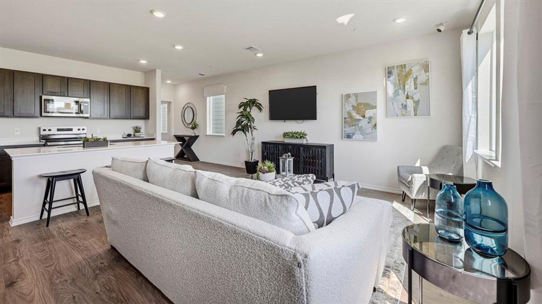 Living room featuring dark wood finished floors and recessed lighting Living room featuring dark wood finished floors and recessed lighting