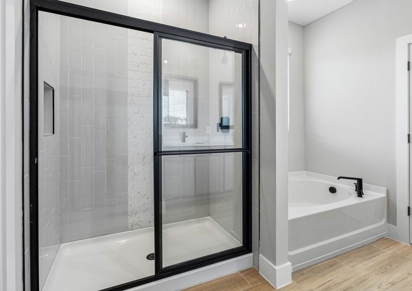 The master bathroom includes dual vanities, a walk-in shower, and a bathtub