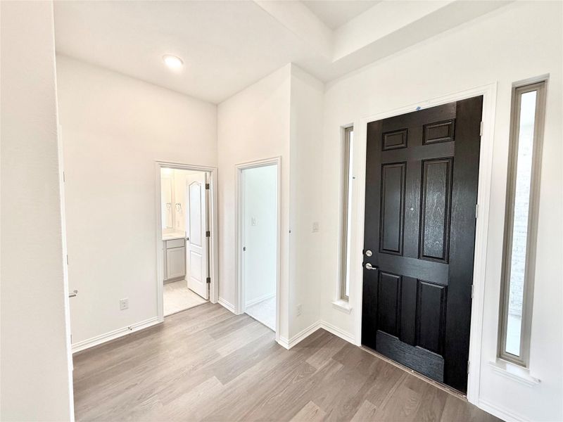Entrance foyer featuring light wood-style flooring and baseboards