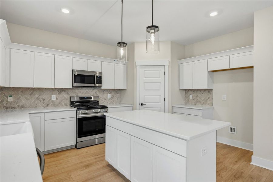 Gleaming stone countertops and modern shaker cabin