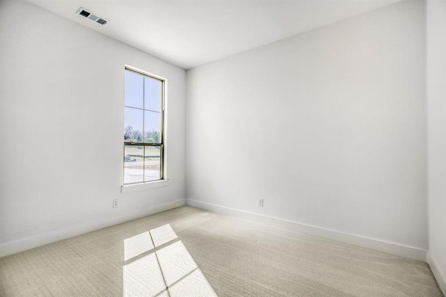 Unfurnished room featuring light colored carpet and baseboards