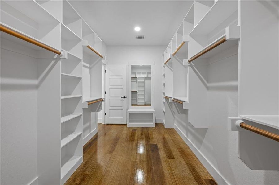 Spacious walk-in closet featuring abundant storage, custom shelving, and ample room for organization, combining functionality with elegant design.