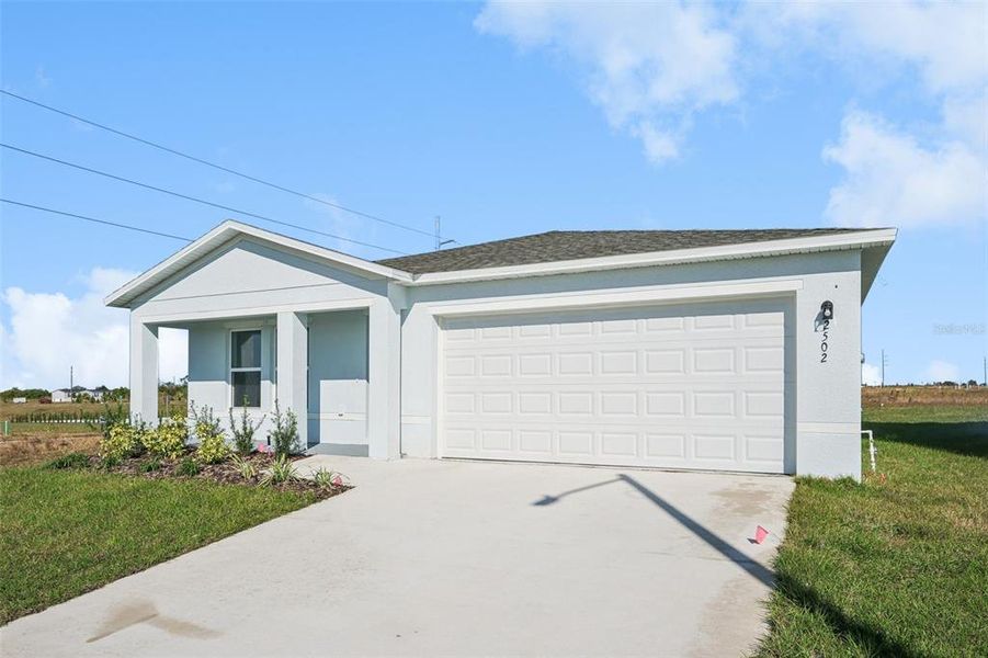 Front exterior of a new home in The Enclave at Scenic Terrace, Haines City, FL, highlighting curb appeal (Image 2).