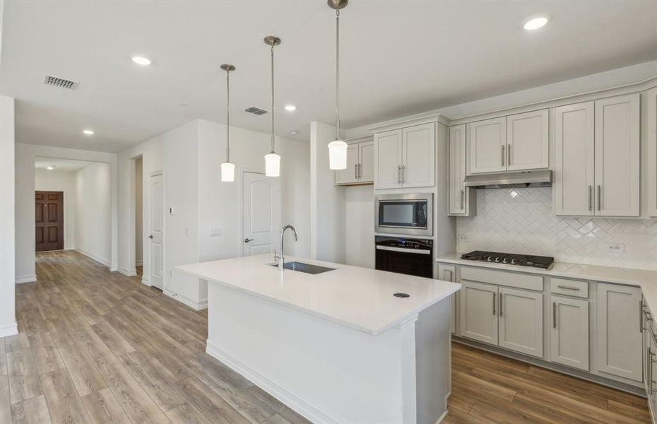 Spacious kitchen with oversized island *real home pictured