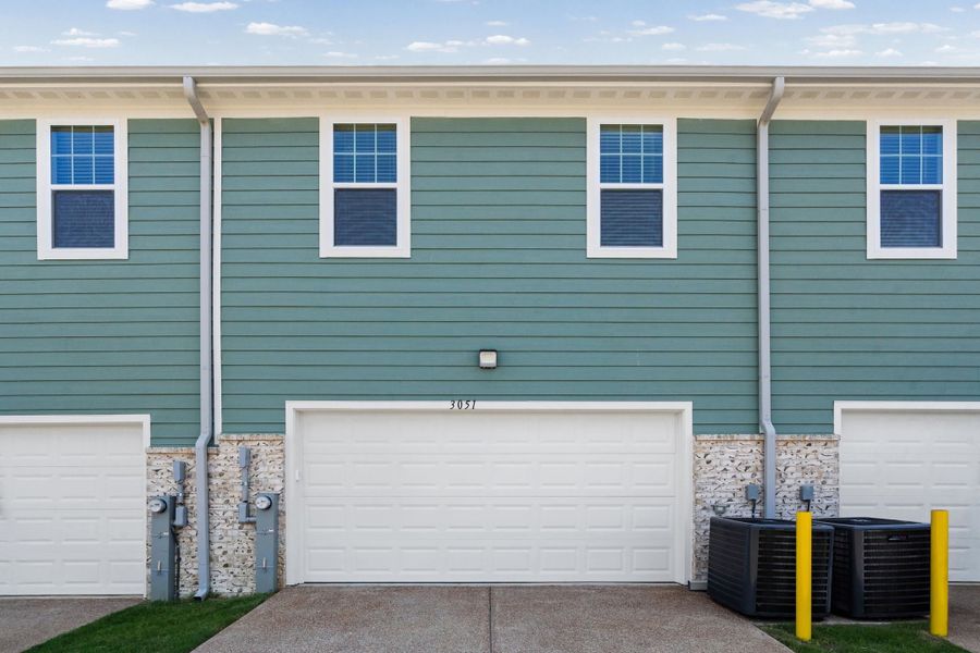Light blue horizontal siding facade with multiple white-framed windows Light blue horizontal siding facade with multiple white-framed windows