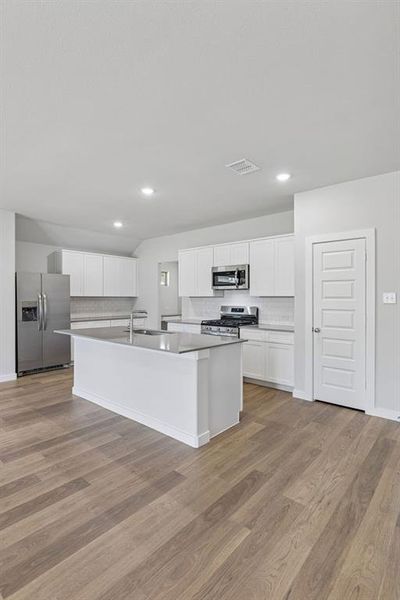 Kitchen in the Harrison home plan by Trophy Signature Homes – REPRESENTATIVE PHOTO