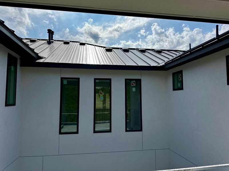 Front exterior of a new home in Las Brisas Estates, Lakeway, TX, highlighting curb appeal (Image 17). Front exterior of a new home in Las Brisas Estates, Lakeway, TX, highlighting curb appeal (Image 17).