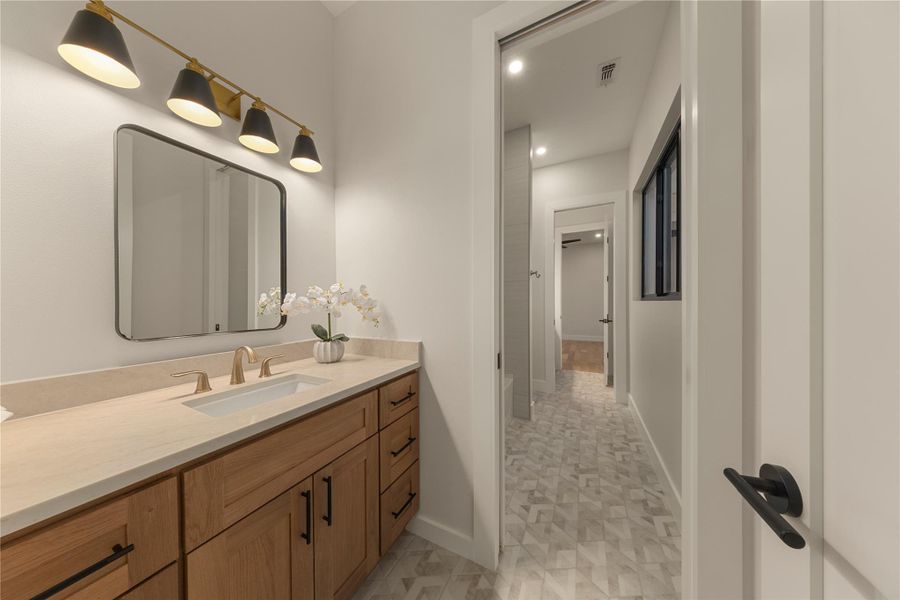 Bathroom with vanity and recessed lighting