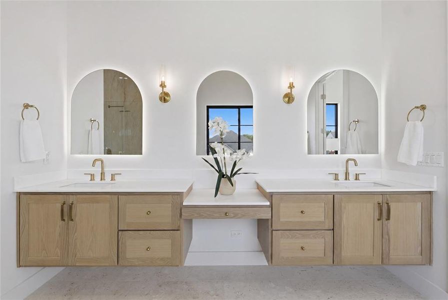 Dual floating vanities with wood-finish cabinetry and brass hardware