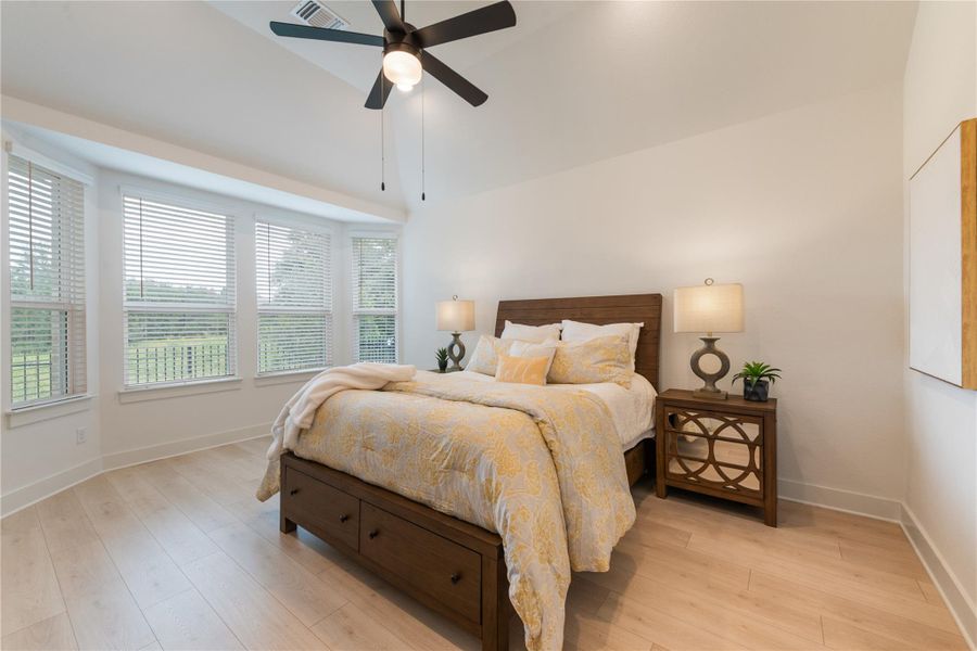 Generous light streams into this bedroom, featuring vaulted ceilings and light wood flooring. Generous light streams into this bedroom, featuring vaulted ceilings and light wood flooring.