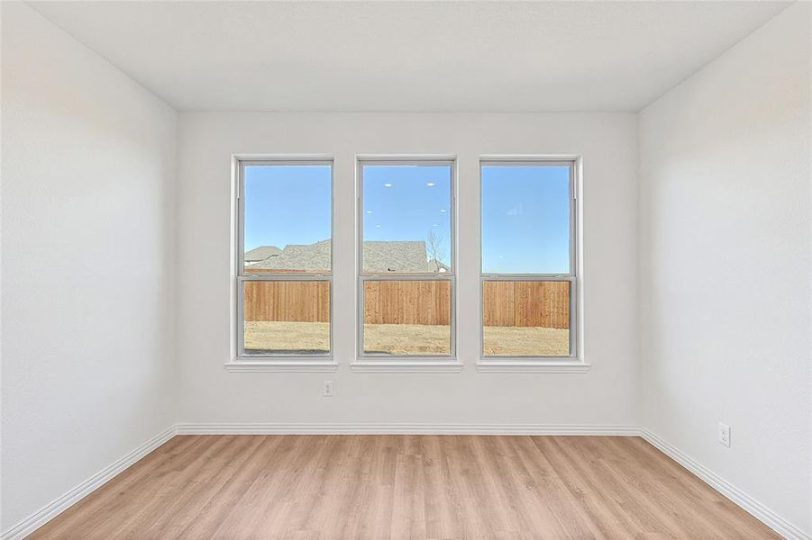 Empty room with light wood finished floors and baseboards