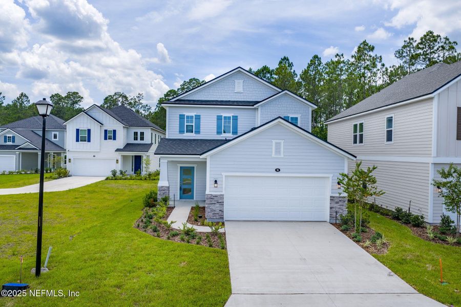 Front exterior of a new home in Beacon Lake, St. Augustine, FL, highlighting curb appeal (Image 29).