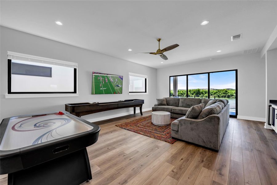 Game room: Spacious living area featuring shuffle board, air hockey, movies & video games.