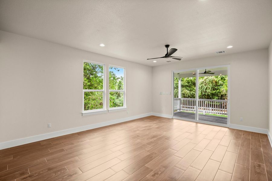 Spare room featuring ceiling fan, healthy amount of natural light, wood finished floors, and recessed lighting