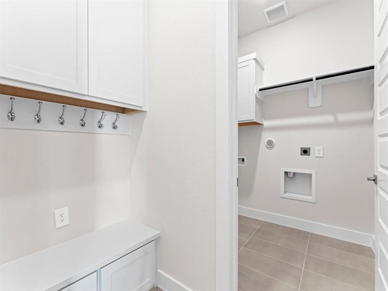 Built-in Bench with Hooks and Storage Cabinets to Keep You Organized