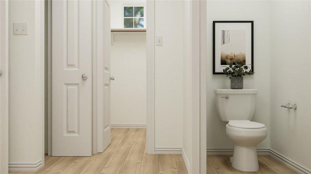 Bathroom featuring hardwood / wood-style flooring and toilet