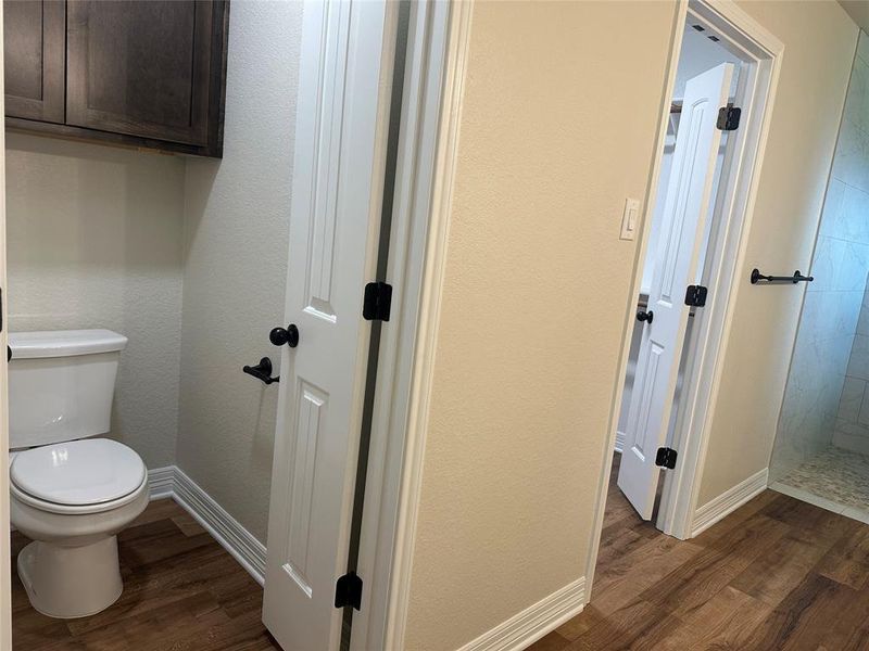 Bathroom with wood finished floors and tiled shower Bathroom with wood finished floors and tiled shower
