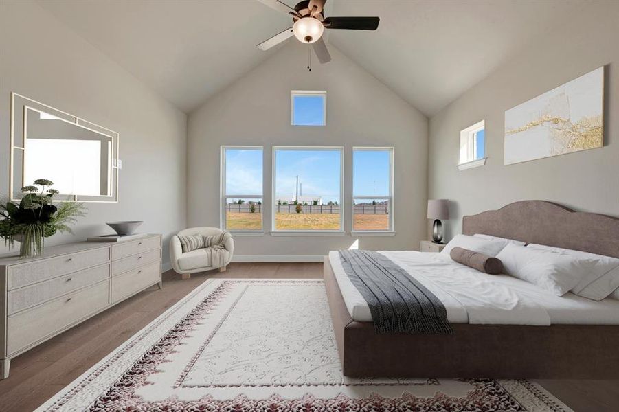 Bedroom with a ceiling fan, a high ceiling, and wood finished floors Bedroom with a ceiling fan, a high ceiling, and wood finished floors