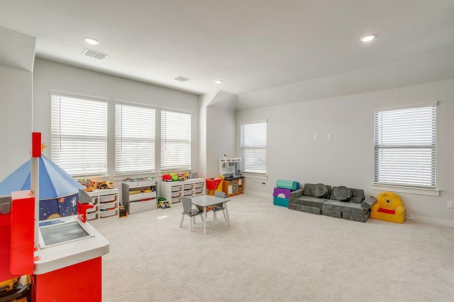 Game room with light carpet, plenty of natural light, and recessed lighting Game room with light carpet, plenty of natural light, and recessed lighting