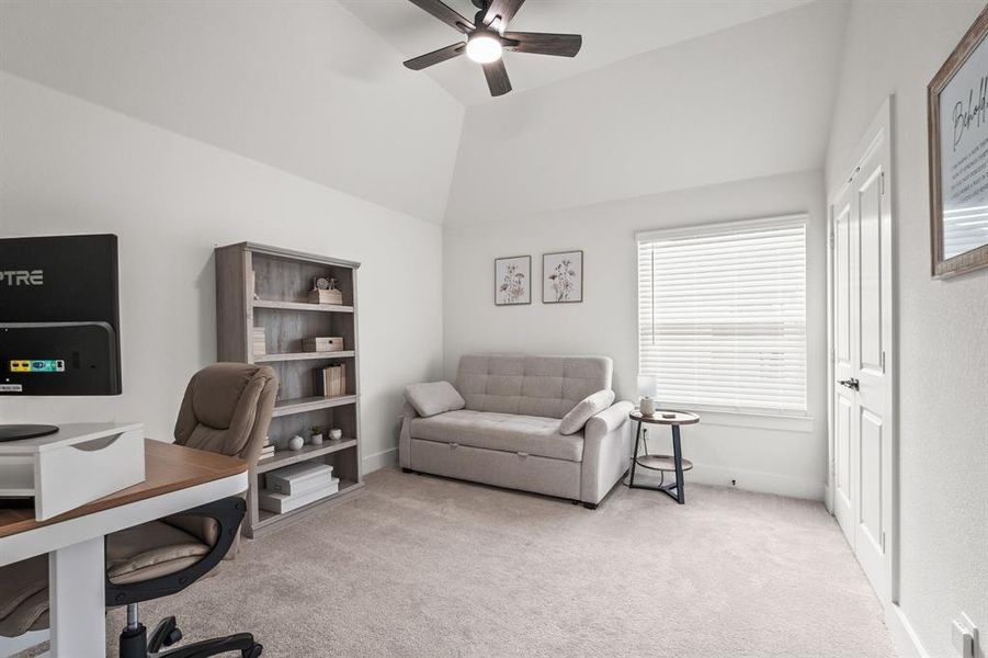Office featuring light colored carpet, ceiling fan, and lofted ceiling Office featuring light colored carpet, ceiling fan, and lofted ceiling