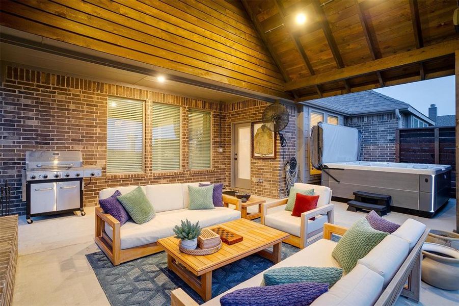 View of patio / terrace with an outdoor hangout area, grilling area, and a hot tub