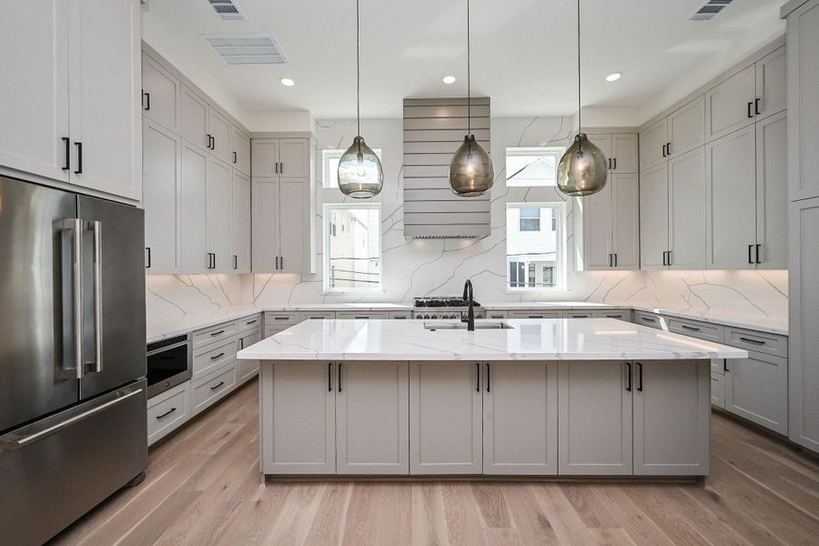 2nd Floor Large Kitchen with Quartz Countertops, and TONS of storage space.  Jenn Aire appliances. Visual Comfort Lighting.  Top Knobs Hardware. Lots of Natural Light. 10' Ceilings. Virtually Staged.