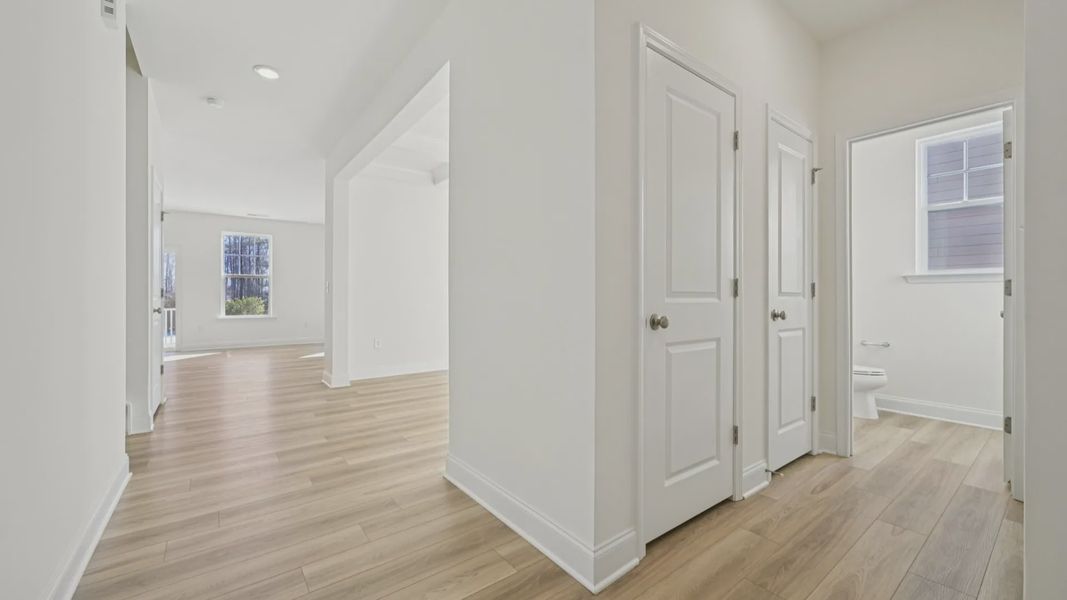 Wagener home plan front entry and powder bath leading into dining room