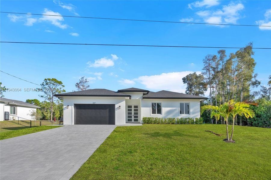 Front exterior of a new home in , Lehigh Acres, FL, highlighting curb appeal (Image 21).