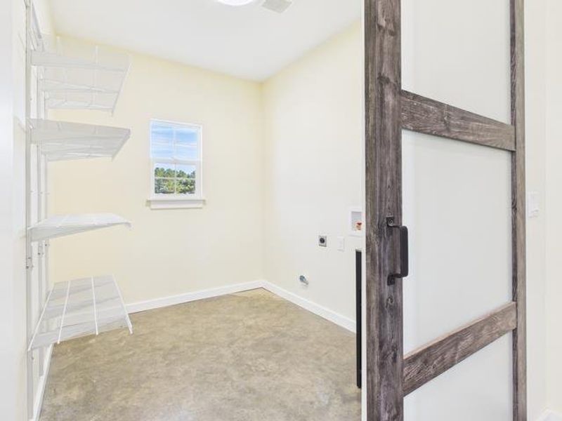 Washroom with hookup for a washing machine and hookup for an electric dryer