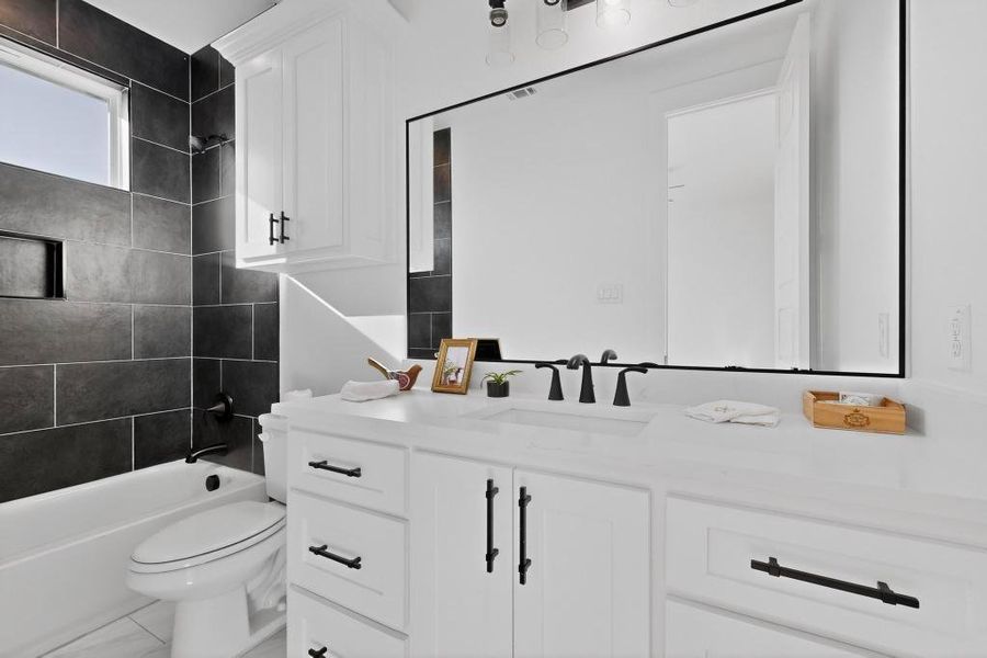 Full bathroom featuring vanity and washtub / shower combination Full bathroom featuring vanity and washtub / shower combination