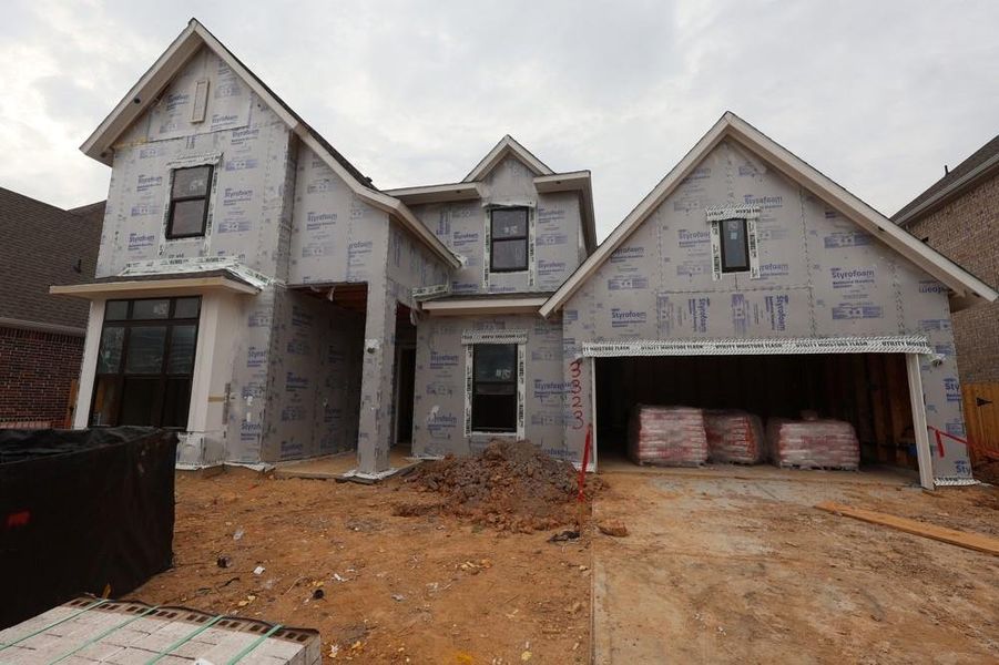 Front exterior of a new home in The Meadows at Imperial Oaks, Conroe, TX, highlighting curb appeal (Image 8). Front exterior of a new home in The Meadows at Imperial Oaks, Conroe, TX, highlighting curb appeal (Image 8).