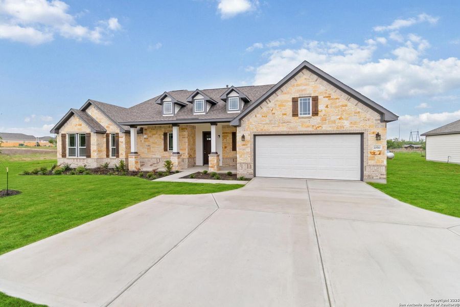 Front exterior of a new home in Jordan's Ranch, San Antonio, TX, highlighting curb appeal (Image 15).
