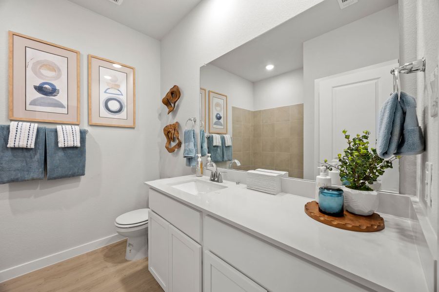 A bathroom with a large mirror. A bathroom with a large mirror.