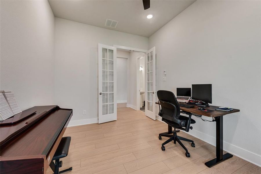 Office with french doors, light wood-type flooring, and recessed lighting